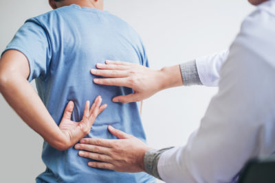 Chiropractor treating a patient after a car accident injury