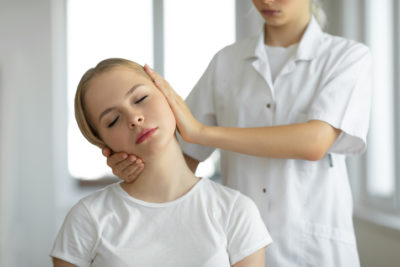 Migraine relief chiropractic adjustment a women's neck 