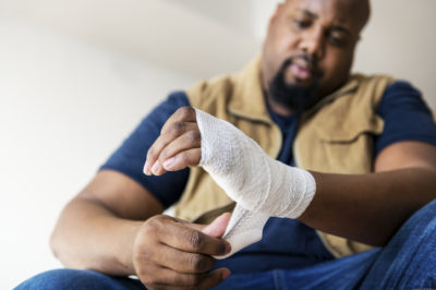 man with wrapped hand common causes of workplace injuries