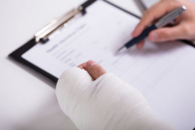 common causes of workplace injuries person filling out paperwork